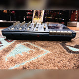 Tascam Portastudio 414 MKII, blue: front edge at an angle with the transport keys and faders