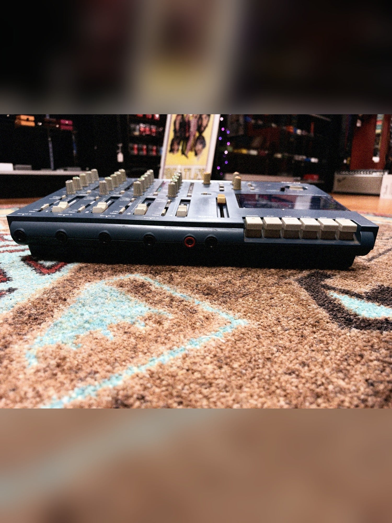 Tascam Portastudio 414 MKII, blue: front edge at an angle with the transport keys and faders