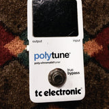 TC Electronic PolyTune Poly-Chromatic Tuner, white: top with the scratched display window, the polytune print and the true bypass footswitch