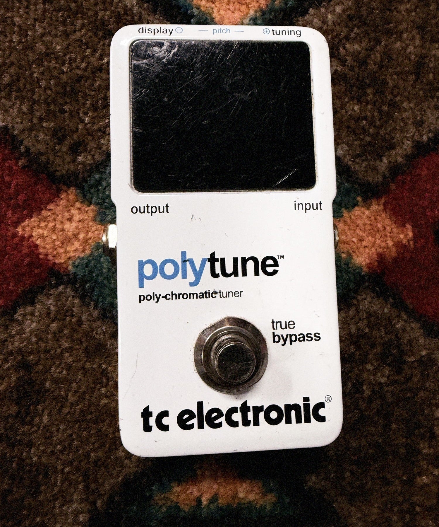 TC Electronic PolyTune Poly-Chromatic Tuner, white: top with the scratched display window, the polytune print and the true bypass footswitch