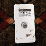 TC Electronic PolyTune Poly-Chromatic Tuner, white: bottom with the battery thumbscrew, glue marks and the label reading Manufactured in Thailand, 9V DC 45mA