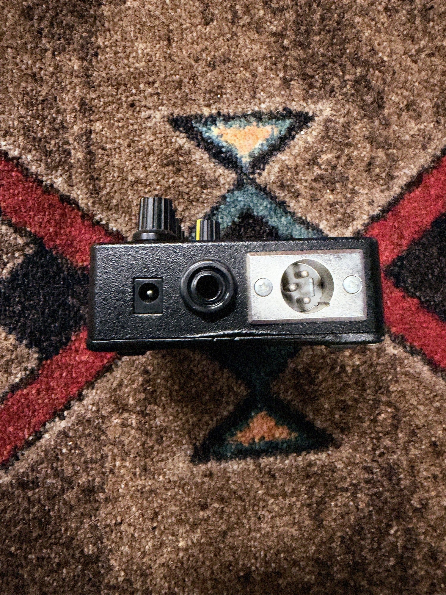 Tech 21 SansAmp Acoustic DI, black: left end with the power jack, the 1/4 inch output and the XLR output
