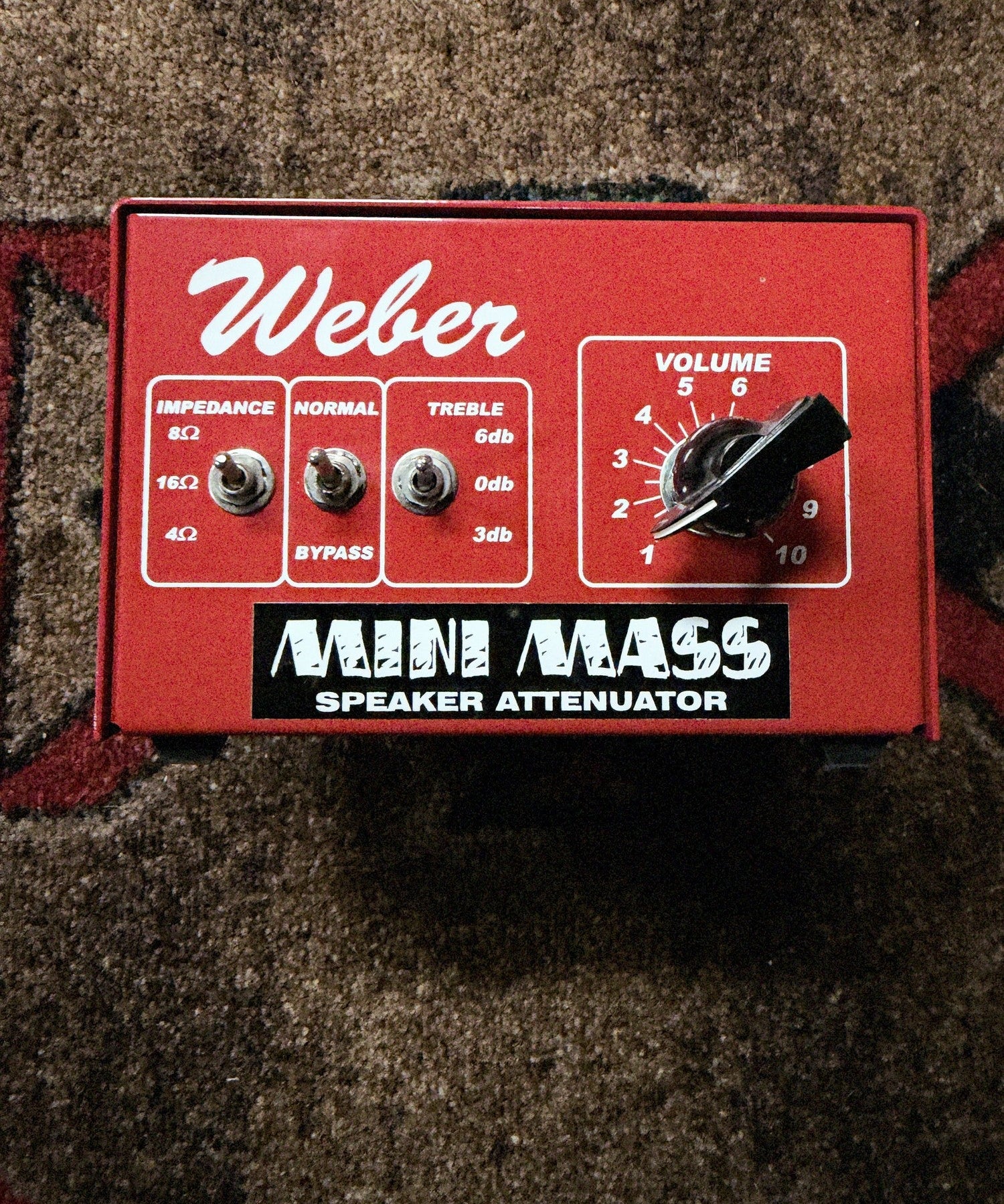 Weber MiniMASS 50-watt attenuator, red: front panel with the Impedance, Normal and Bypass, and Treble switches and the Volume knob