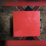 Weber MiniMASS 50-watt attenuator, red: top of the enclosure, with a few small light specks near one edge